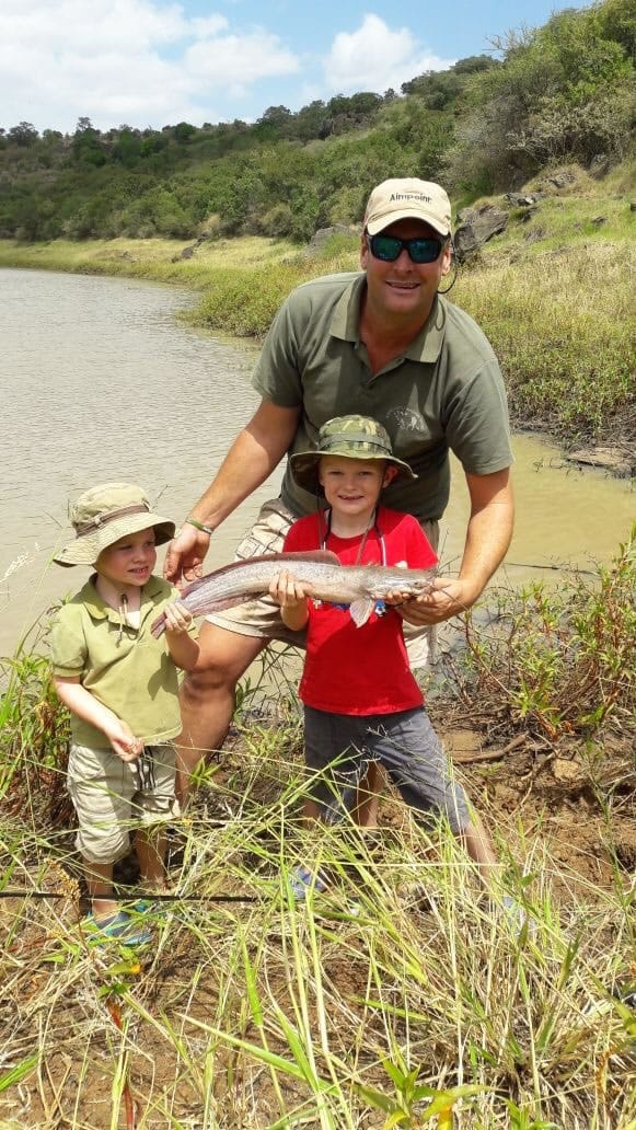 General Manager and head of our team Sean Outram with his sons, holding a fish